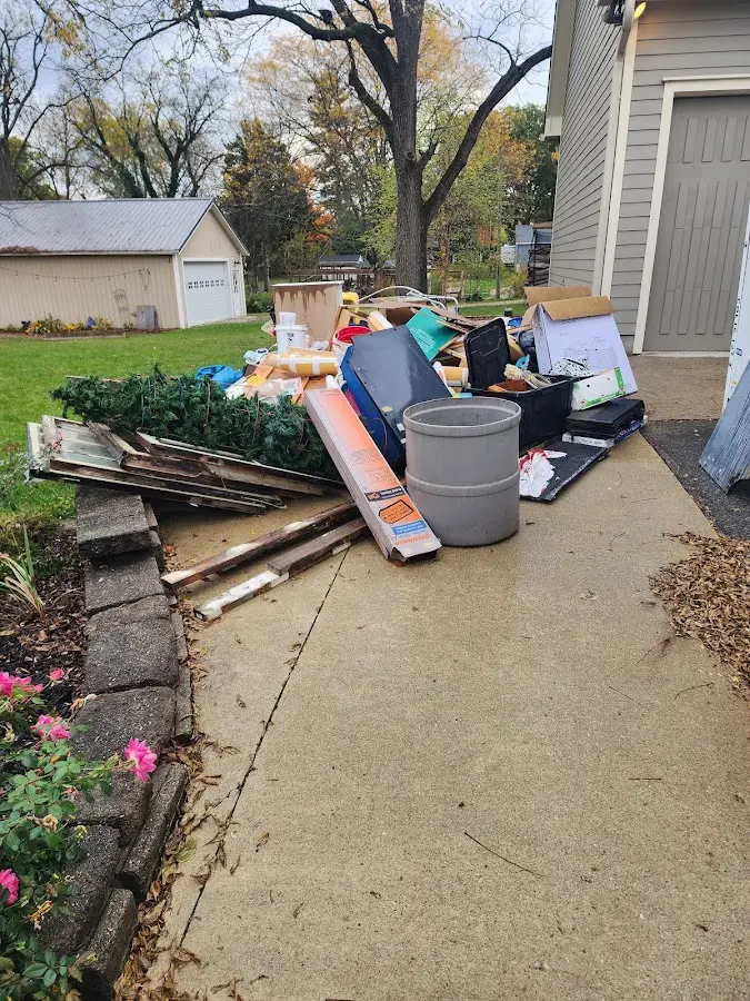 Dumpster being loaded with debris for 12 Yard Dumpster Rental in Holmdel